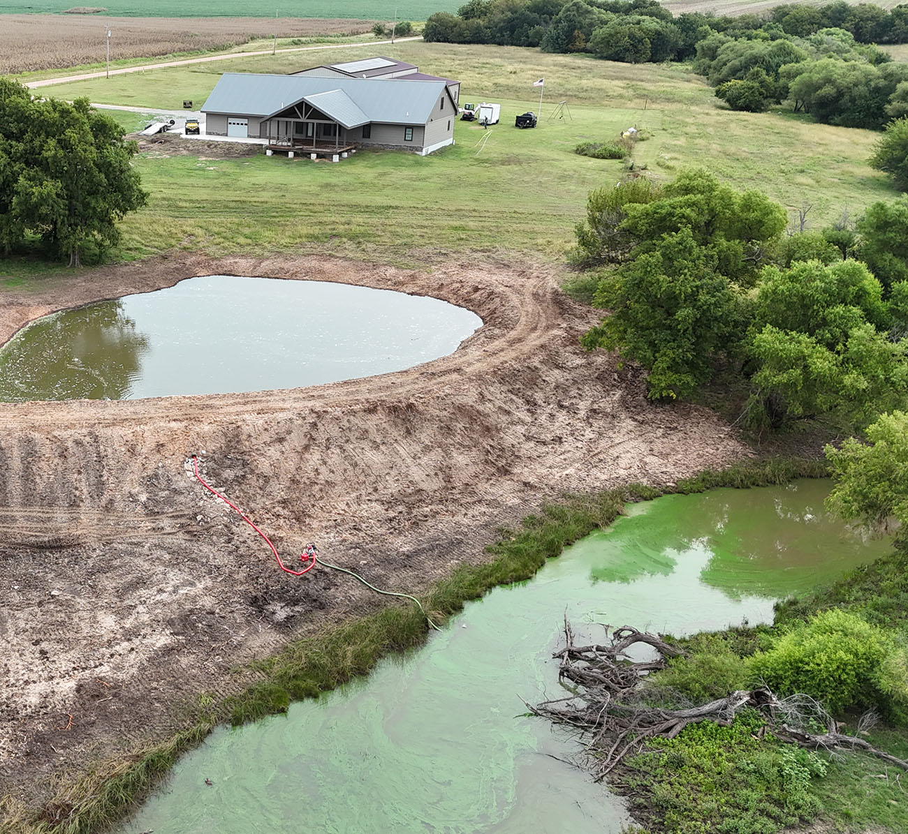 Newly excavated pond basin filled with water